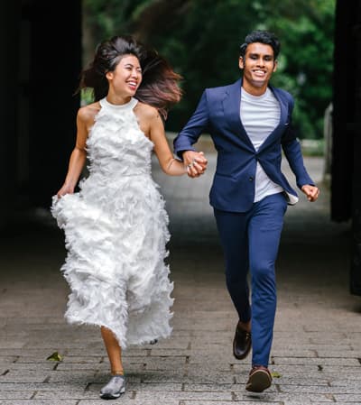 running bride and groom holding hands