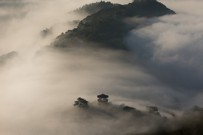 A photo of large mountains in Asia, covered in a thick fog